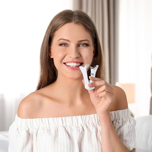 une femme charmante toute souriante montrant le pinceau des faux cils